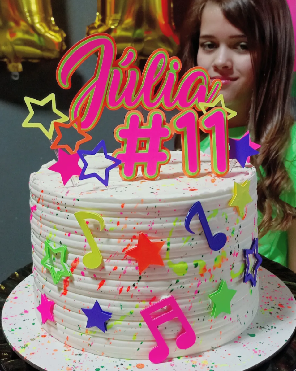 Bolo de aniversário colorido com estrelas e notas musicais